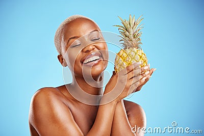 Happy black woman, pineapple and diet for natural nutrition or health against a blue studio background. African female Stock Photo