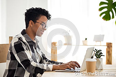 Happy black woman work at laptop having morning coffee Stock Photo