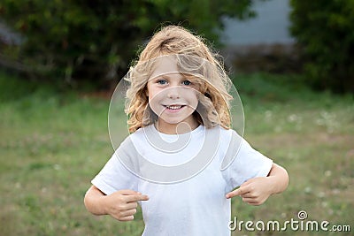 Happy blond child indicating himself an loughing Stock Photo