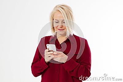 Happy blonde middle aged woman in red suit isolated on white background holding phone Stock Photo