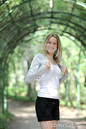Happy blonde woman in park Stock Photo