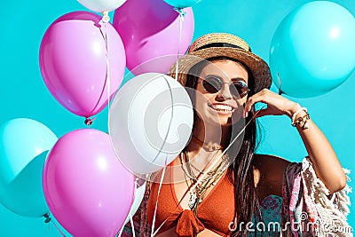 Happy bohemian girl standing with helium balloons Stock Photo