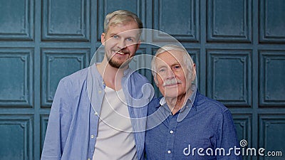 Happy bonding loving different male generations family of senior father and adult son or grandson Stock Photo