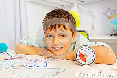 Happy boy during ABA therapy and lesson timer Stock Photo