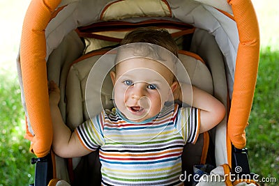 Happy boy in the baby carriage Stock Photo