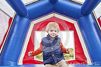 Happy boy in bounce house Stock Photo