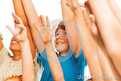 Happy boy in the crowd with lifted hands Stock Photo