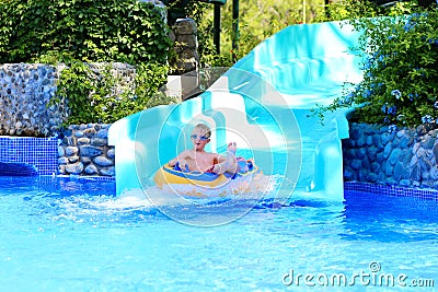 Happy boy enjoying waterslide Stock Photo