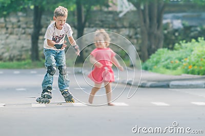Happy boy faving fun on roller scates on natural backgroun Stock Photo