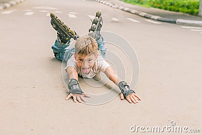Happy boy faving fun on roller scates on natural backgroun Stock Photo
