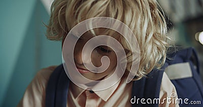 Happy boy having fun on school break close up. Smiling kid looking down playing. Stock Photo