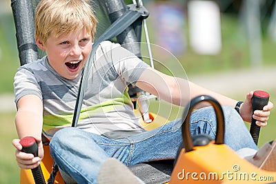 Happy boy having fun at summer bobsled track Stock Photo