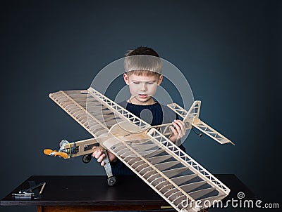 Happy boy holding the model airplane Stock Photo