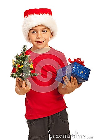 Happy boy holding Xmas tree and gift Stock Photo