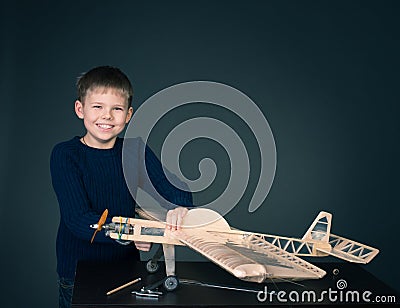 Happy boy with model airplane. Airplane modeling hobby. Stock Photo