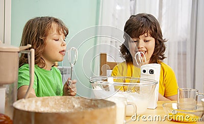 Happy boy preparing the cream, bake cookies in the kitchen. family funny Stock Photo