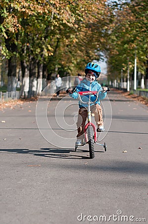 Happy boy riding his little bicycle Stock Photo