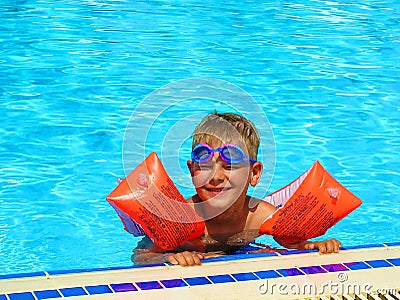 Happy boy swimming in outdoor pool in arm ruffles Stock Photo