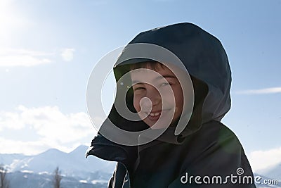 happy boy walking in sunny mountains children's clothing for the mountains close smiling portrait Stock Photo