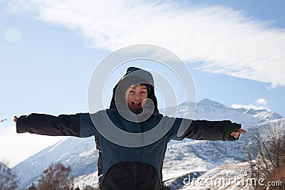 happy boy walking in sunny mountains children's clothing for the mountains close smiling portrait Stock Photo