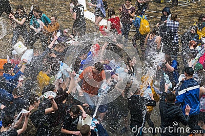 Happy boys & girls pouring water on each other. Editorial Stock Photo