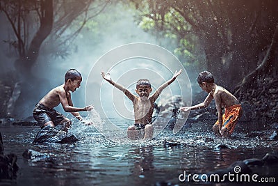 Happy boys has fun playing in the creek Stock Photo