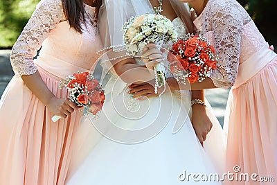 happy bride and bridesmaids showing their luxury bouquets at gorgeous wedding reception Stock Photo