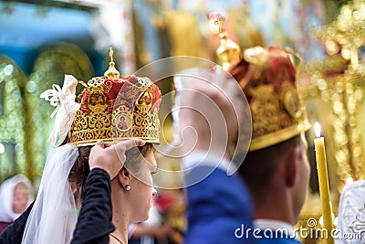 Happy bride groom in crowns at wedding ceremony in church Editorial Stock Photo