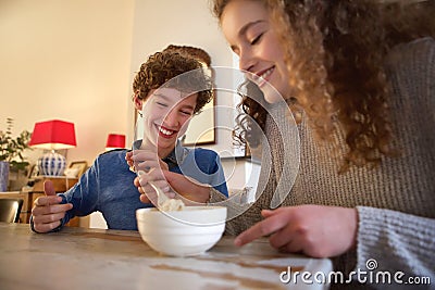 Happy brother and sister eating food Stock Photo