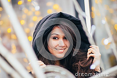 Happy brunette in a hood - Eastern nationality - big eyes and a wide smile Stock Photo