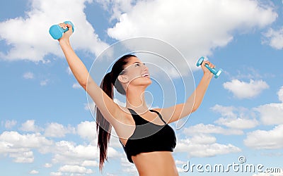 Happy brunette woman toning her muscles Stock Photo