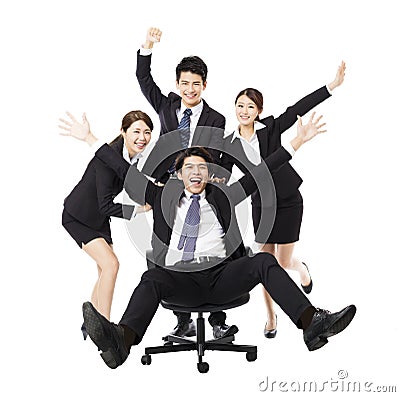 Happy Business group push colleague sitting in chair Stock Photo