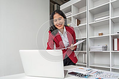 Happy business lady working on laptop in office, Asian happy beautiful businesswoman in formal suit work in workplace Stock Photo