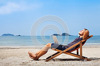 Happy business man on the beach Stock Photo