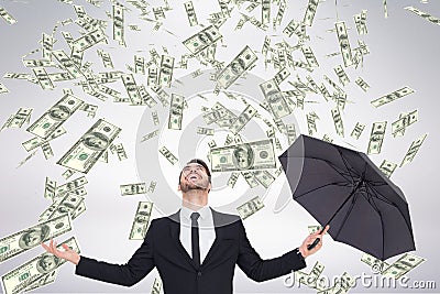 Happy business man looking at money rain against white background Stock Photo