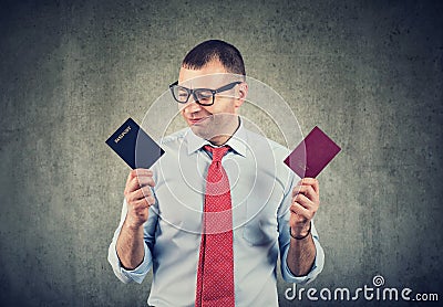 Happy business man with two passports, dual citizenship Stock Photo