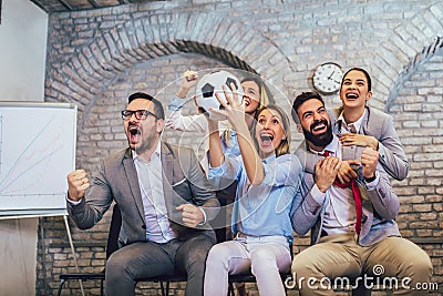 Business people or football fans watching soccer on tv and celebrating victory. Friendship, sports and entertainment concept Stock Photo