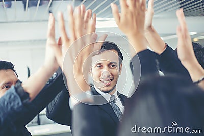 Happy Business people showing team work and giving five after s Stock Photo