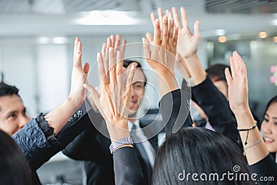 Happy Business people showing team work and giving five after signing agreement or contract with foreign partners in office Stock Photo