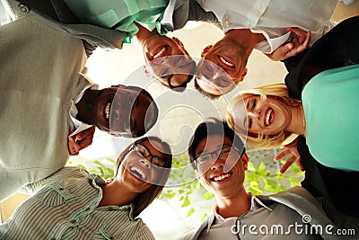 Happy business people with their heads together Stock Photo