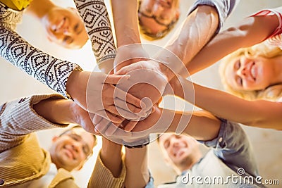 Happy business team joining their hands Stock Photo