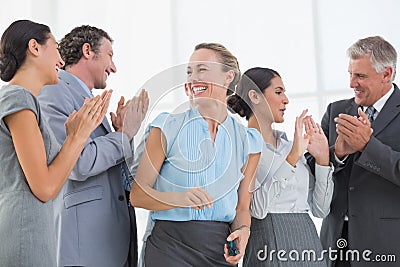 Happy business team smiling at each other Stock Photo