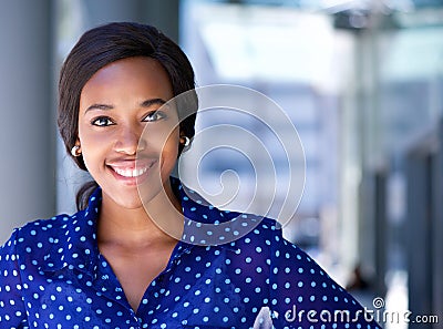 Happy business woman smiling outside office building Stock Photo