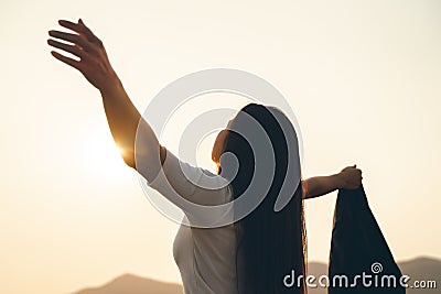Happy business woman spreading arms and watching the mountain silhouette. Business success concept, freedom emotions Stock Photo