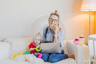 Happy business woman with toddler working on computer Stock Photo