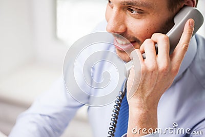 Happy businessman calling on phone at office Stock Photo