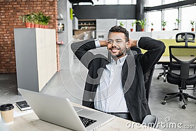 Happy businessman having fun at work. Young smiling professional men resting during the working day at office. Stock Photo