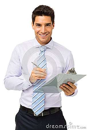 Happy Businessman Holding Clipboard And Pen Stock Photo