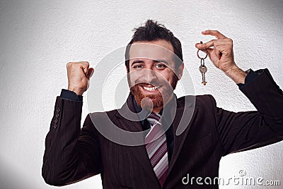 Happy businessman holding a house key Stock Photo