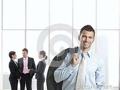 Happy businessman in office lobby Stock Photo